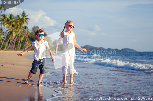 Image of Happy children playing on the beach at the day time.