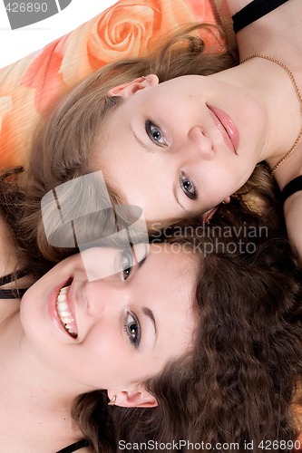 Image of Portrait of the two beauty young women laying on a pillow 3