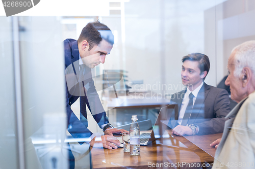 Image of Business people sitting and brainstorming at corporate meeting.