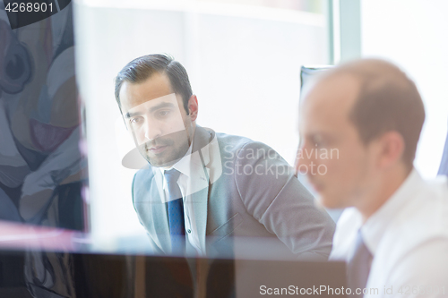 Image of Business team analyzing data at business meeting.