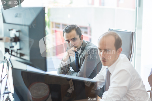 Image of Business team analyzing data at business meeting.