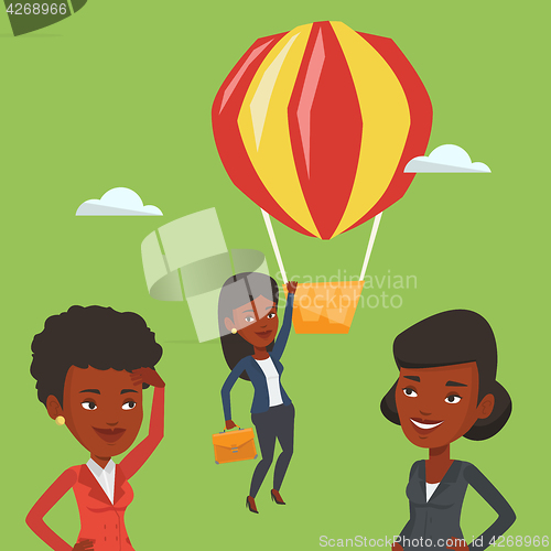 Image of Business woman hanging on balloon.