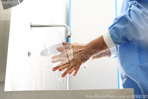 Image of Surgical hand disinfection. The doctor washes his hands. The doctor disinfects  his hands. Surgeon washing hands.