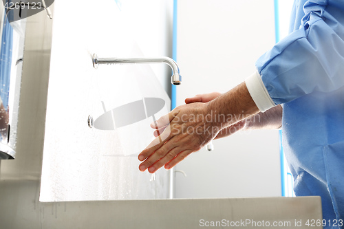 Image of Surgeon washing hands.