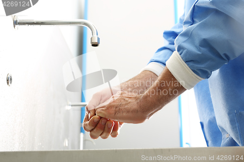 Image of Surgical hand disinfection. The doctor washes his hands.