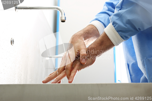 Image of Surgical hand disinfection. The doctor washes his hands.