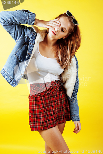 Image of lifestyle people concept: pretty young school teenage girl having fun happy smiling on yellow background
