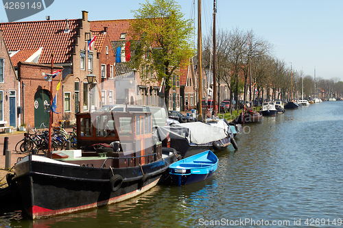 Image of Traditional Dutch Botter Fishing Boats in the small Harbor of the Historic Fishing Village in Netherlands.