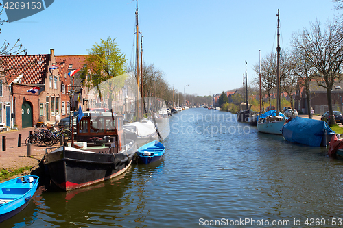 Image of Traditional Dutch Botter Fishing Boats in the small Harbor of the Historic Fishing Village in Netherlands.