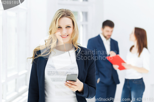 Image of Portrait of businesswoman talking on phone in office