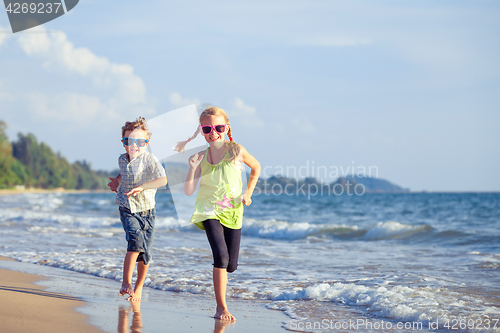 Image of Happy children playing on the beach at the day time.