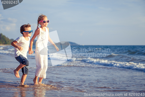 Image of Happy children playing on the beach at the day time.