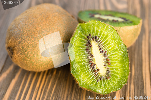 Image of Whole Food Fruit Green Kiwi Halves Seeds Cutting Board