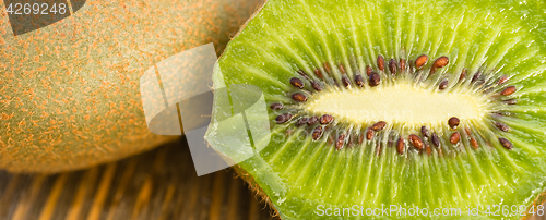 Image of Whole Food Fruit Green Kiwi Halves Seeds Cutting Board