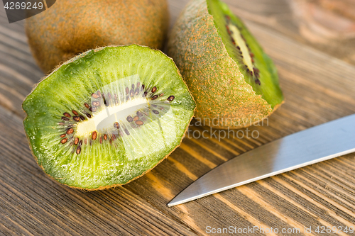 Image of Whole Food Fruit Green Kiwi Halves Knife Cutting Board