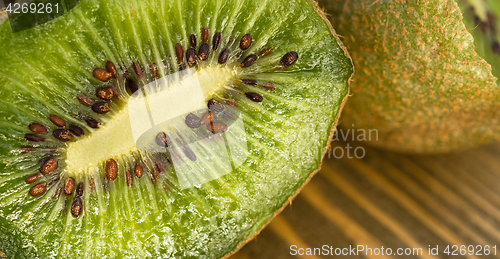 Image of Whole Food Fruit Green Kiwi Halves Seeds Cutting Board