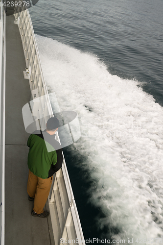 Image of Speeding Ferry Boat Wake of Ocean Spray Man Looking