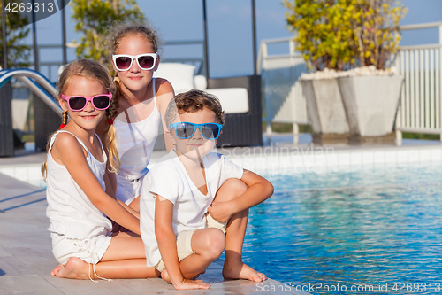 Image of happy children  playing on the swimming pool at the day time.