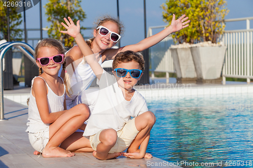 Image of happy children  playing on the swimming pool at the day time.