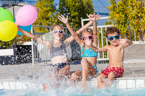 Image of happy children  playing on the swimming pool at the day time.