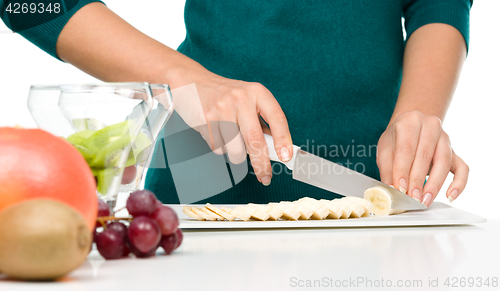 Image of Cook is chopping banana for fruit dessert