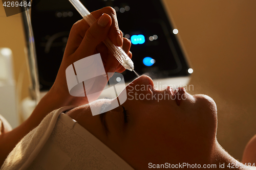 Image of Face Beauty Treatment. Closeup Of Beautiful Woman Getting Facial Gas-liquid Oxygen Water Epidermal Peeling Using Professional Equipment At Cosmetology Center. Skin Care Concept.