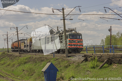 Image of Green freight train transports cargo by rail