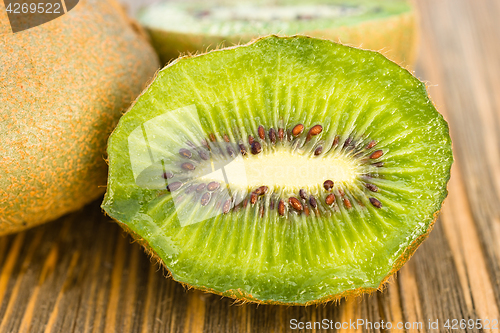 Image of Whole Food Fruit Green Kiwi Halves Seeds Cutting Board