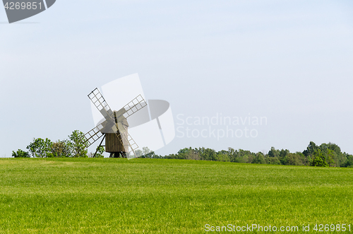 Image of Old wooden windmill in a field