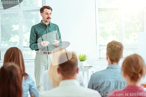 Image of Speaker at Business Meeting in the conference hall.