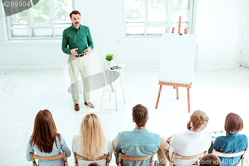 Image of Speaker at Business Meeting in the conference hall.