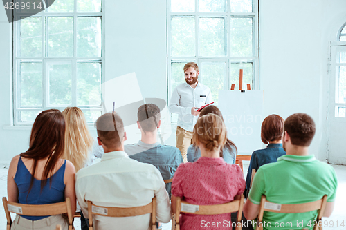 Image of Speaker at Business Meeting in the conference hall.