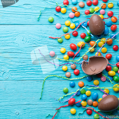 Image of Multicolored sweets, chocolate eggs, ribbons