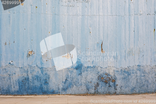 Image of blue abandoned grunge cracked stucco wall