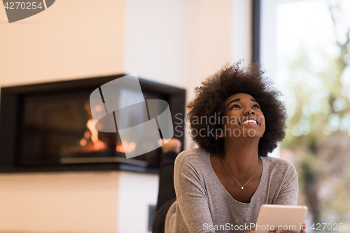 Image of black women using tablet computer on the floor