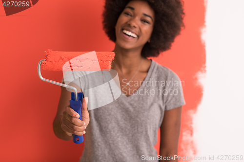 Image of black woman painting wall