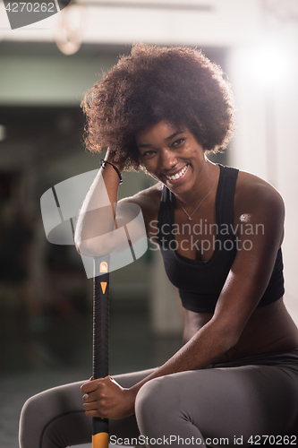 Image of black woman after workout with hammer