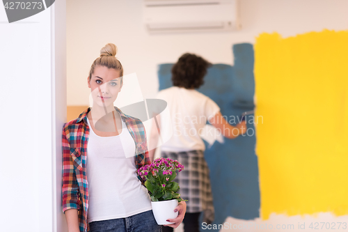 Image of happy young couple doing home renovations