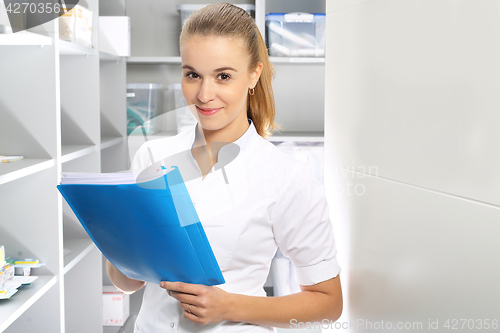 Image of The nurse checks the supply of hospital pharmacy 