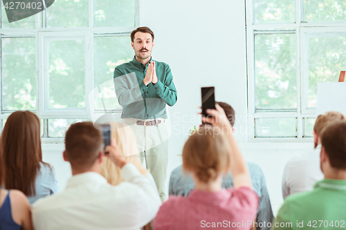 Image of Speaker at Business Meeting in the conference hall.