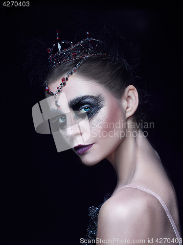 Image of Portrait of the ballerina in the role of a black swan on black background