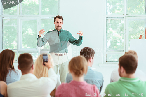 Image of Speaker at Business Meeting in the conference hall.