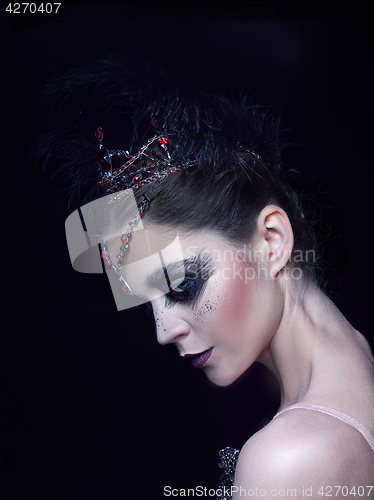 Image of Portrait of the ballerina in the role of a black swan on black background