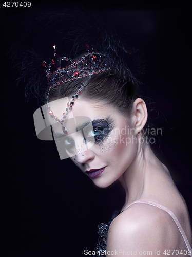 Image of Portrait of the ballerina in the role of a black swan on black background
