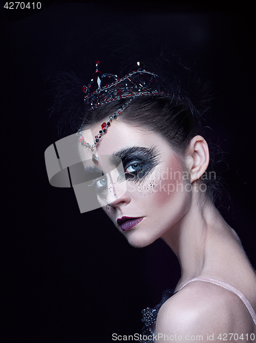 Image of Portrait of the ballerina in the role of a black swan on black background