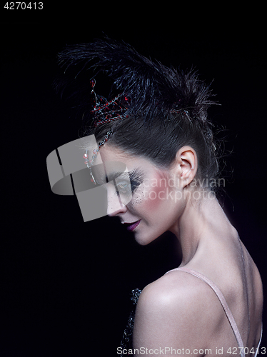 Image of Portrait of the ballerina in the role of a black swan on black background