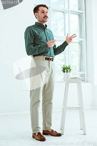 Image of Speaker at Business Meeting in the conference hall.