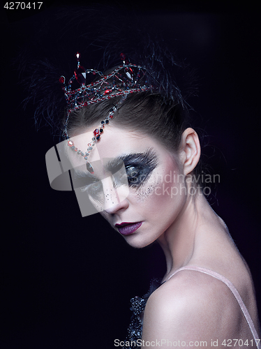 Image of Portrait of the ballerina in the role of a black swan on black background