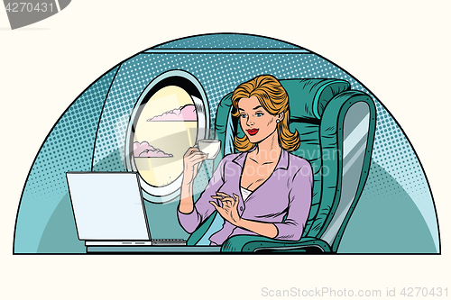 Image of Businesswoman in business class of the aircraft works at a lapto