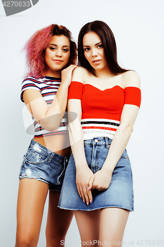 Image of lifestyle people concept: two pretty stylish modern hipster teen girl having fun together, diverse nation mixed races, happy smiling making selfie closeup